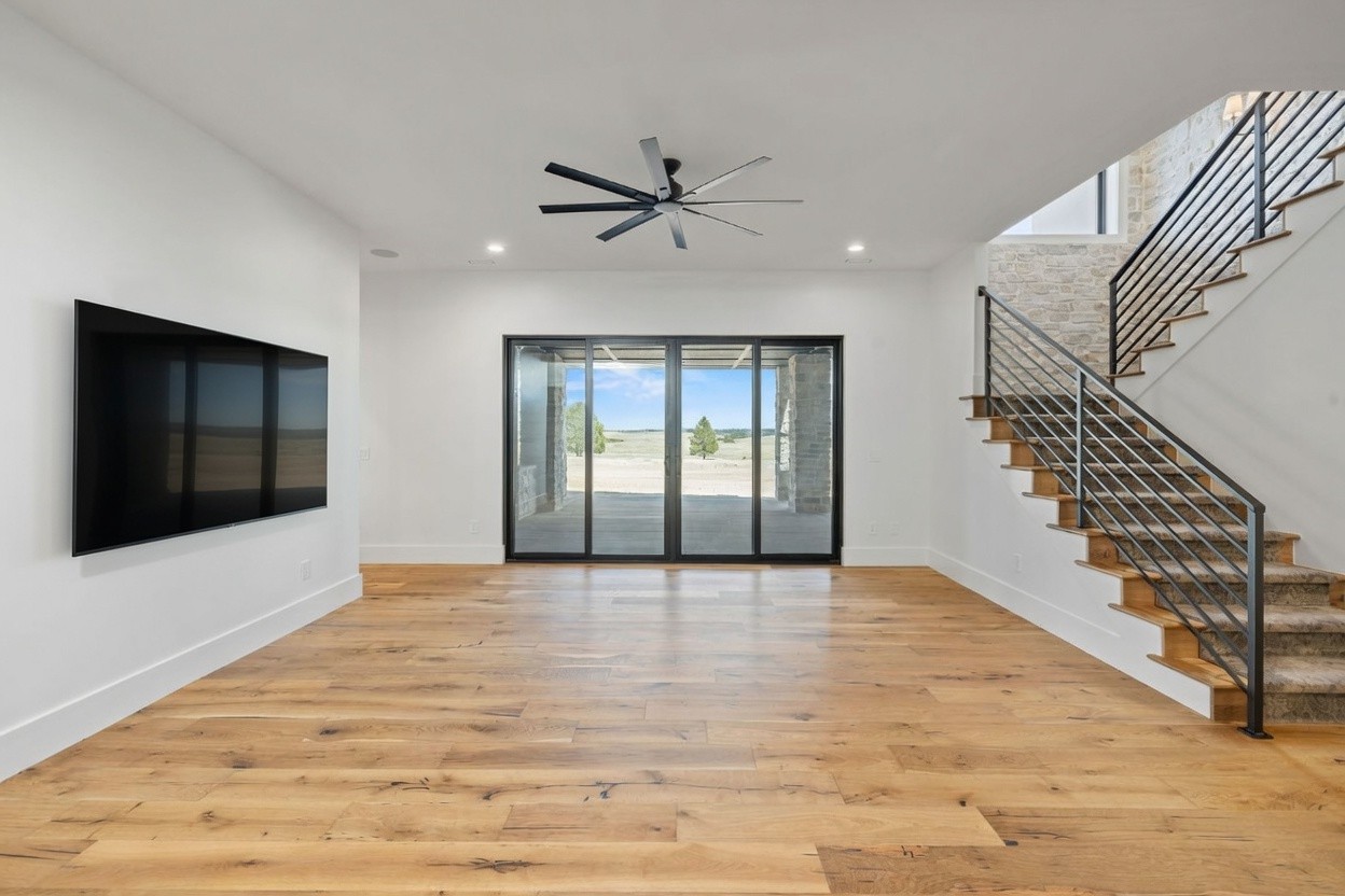 Fumed Oak wood flooring in a modern open-concept living room with glass sliding doors