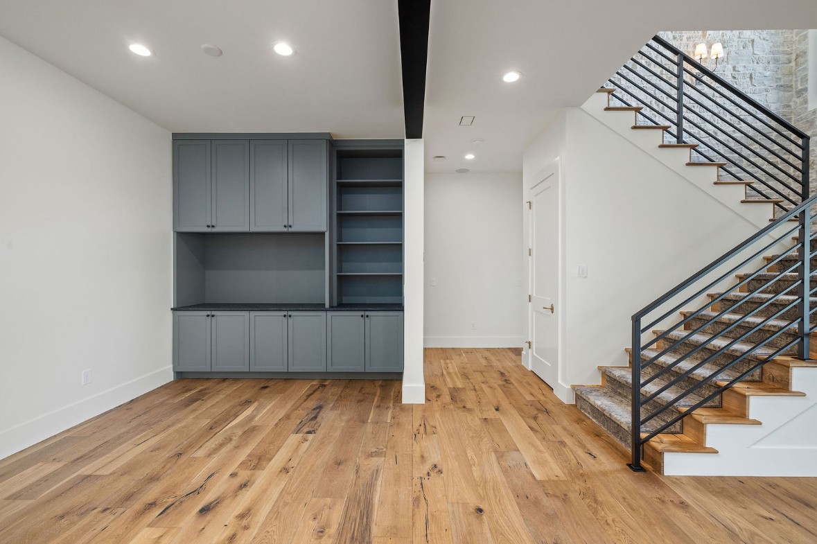 Fumed White Oak hardwood flooring near a staircase with built-in cabinetry
