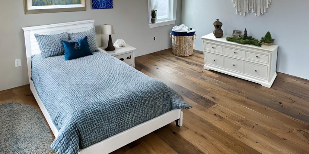 Fumed oak hardwood flooring in a cozy bedroom with blue bedding